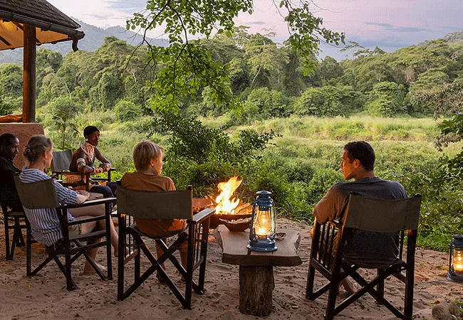 kitich-forest-camp-mathews-range-samburu-region-of-northern-kenya-guests-sit-around-the-fire-pit-with-a-drink-and-share-adventures-from-the-day Kitich Forest Camp Mathews Range Samburu Northern Kenya