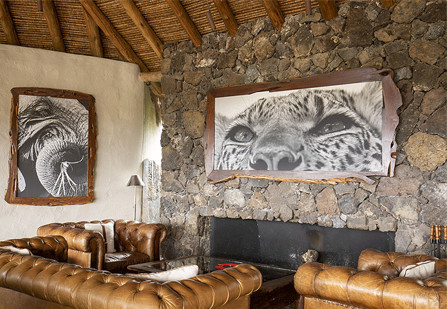 ol-donyo-lodge-chyulu-hills-main-lounge-complete-with-grand-stone-fireplace-a-small-library-inviting-open-bar-and-verandah Ol Donyo Lodge Chyulu Hills Kenya Safari