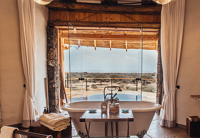 ol-donyo-lodge-chyulu-hills-suites-feature-en-suite bathrooms-including-a-deep-stone-tub-indoor-and-outdoor-showers-and-a-flush-toilet Ol Donyo Lodge Chyulu Hills Kenya Safari