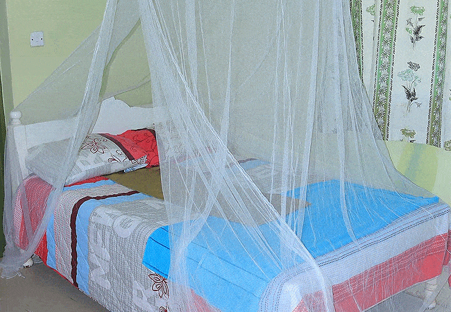 rhino-tourist-tented-camp-masai-mara-bed-with-mosquito-net Rhino Tourist Tented Camp Masai Mara