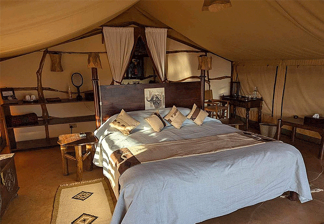 elerai-camp-amboseli-accommodate-single-beds-double-beds-and-triple beds-and-sitting-on-the-bed-one-can-clearly-see-mt-kilimanjaro Elerai Camp Amboseli National Park Kenya Safari