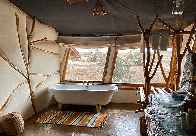 satao-safari-camp -tsavo-east-national-park-suites-feature-en-suite-bathrooms-with-both-showers and-bathtubs Satao Safari Camp Tsavo East National Park